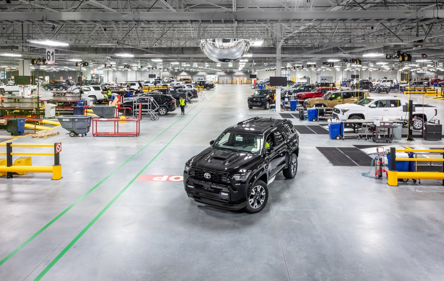 Interior view photo of integrated work areas focused on safety, visibility, and efficient vehicle flow across the processing floor.