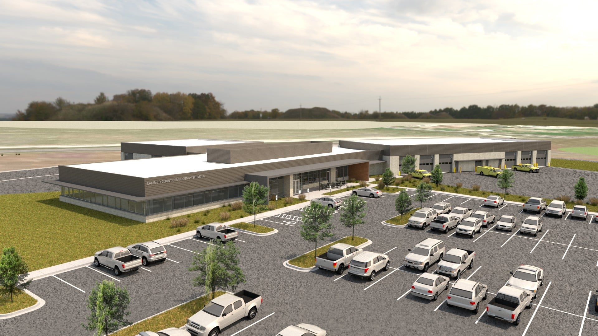 Aerial rendering of Larimer County Emergency Services Building with emergency vehicle bays and parking area