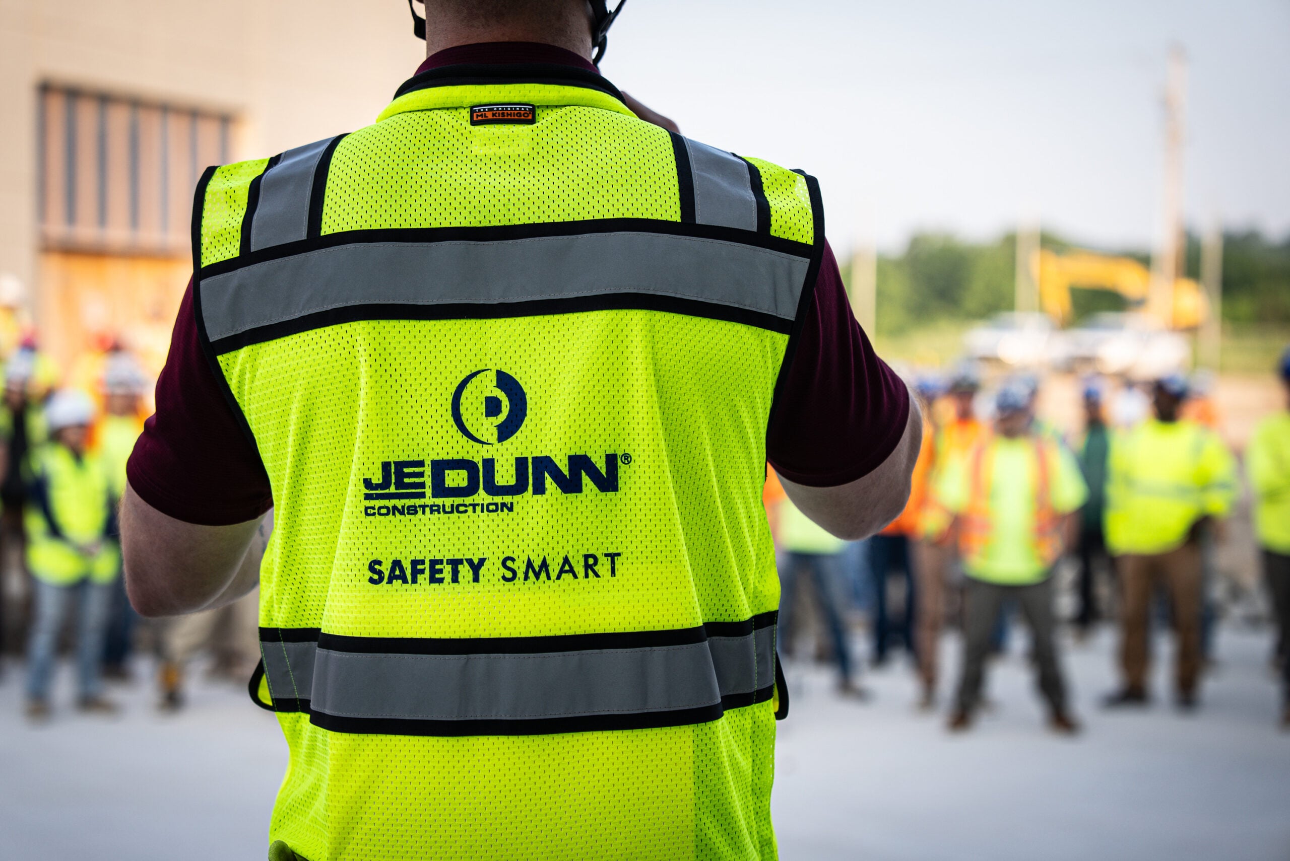 - JE Dunn Construction Construction safety meeting in active jobsite environment focused on worker safety and coordination