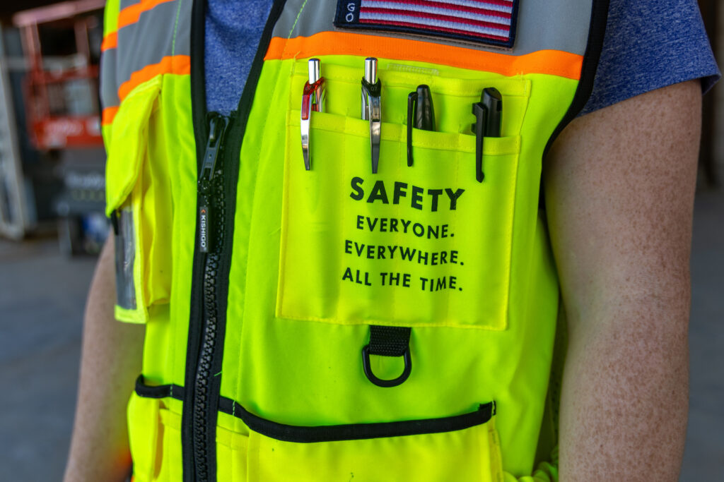 Construction worker safety vest highlighting worker safety and EHS practices on jobsite
