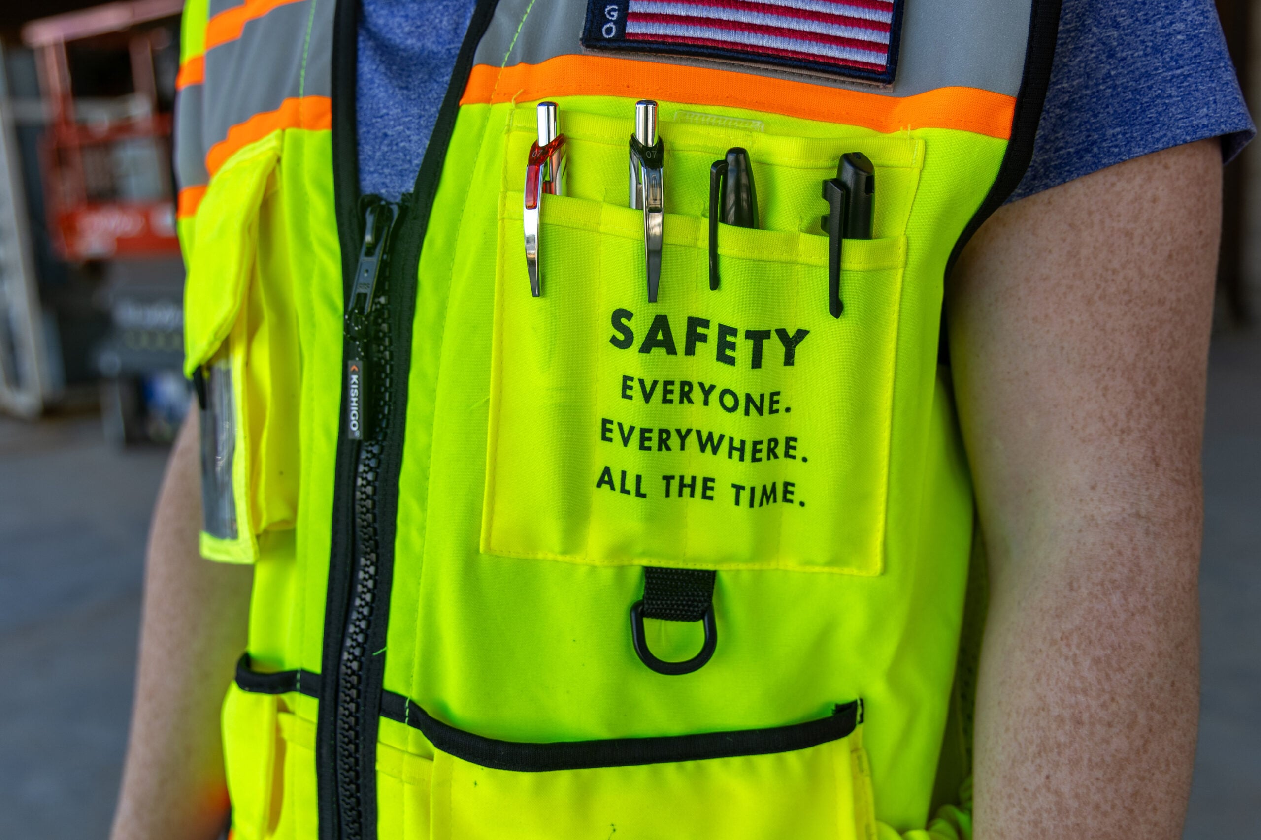 Construction worker safety vest highlighting worker safety and EHS practices on jobsite