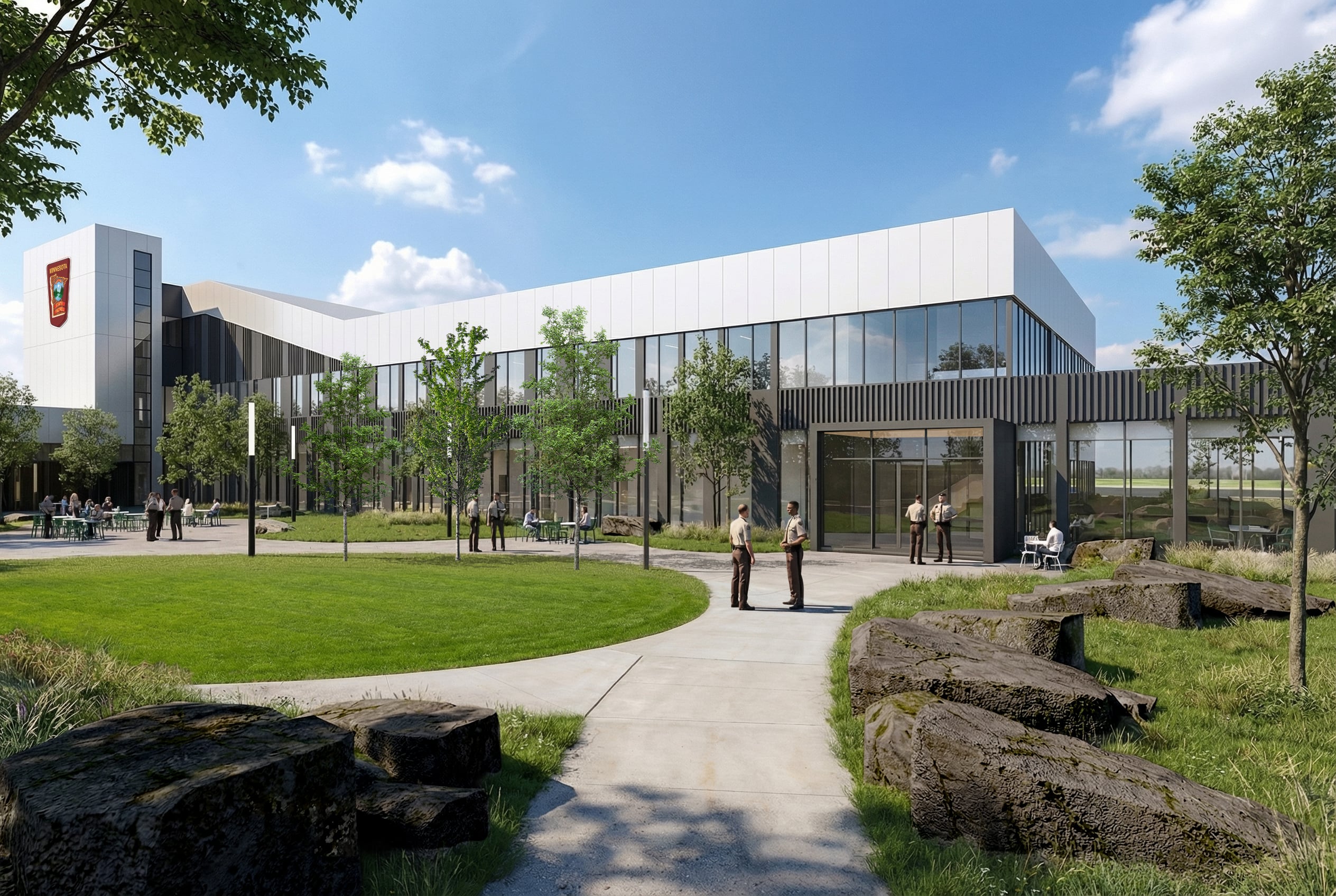 Exterior view of the Minnesota State Patrol Headquarters featuring the signature red façade and secure campus setting.