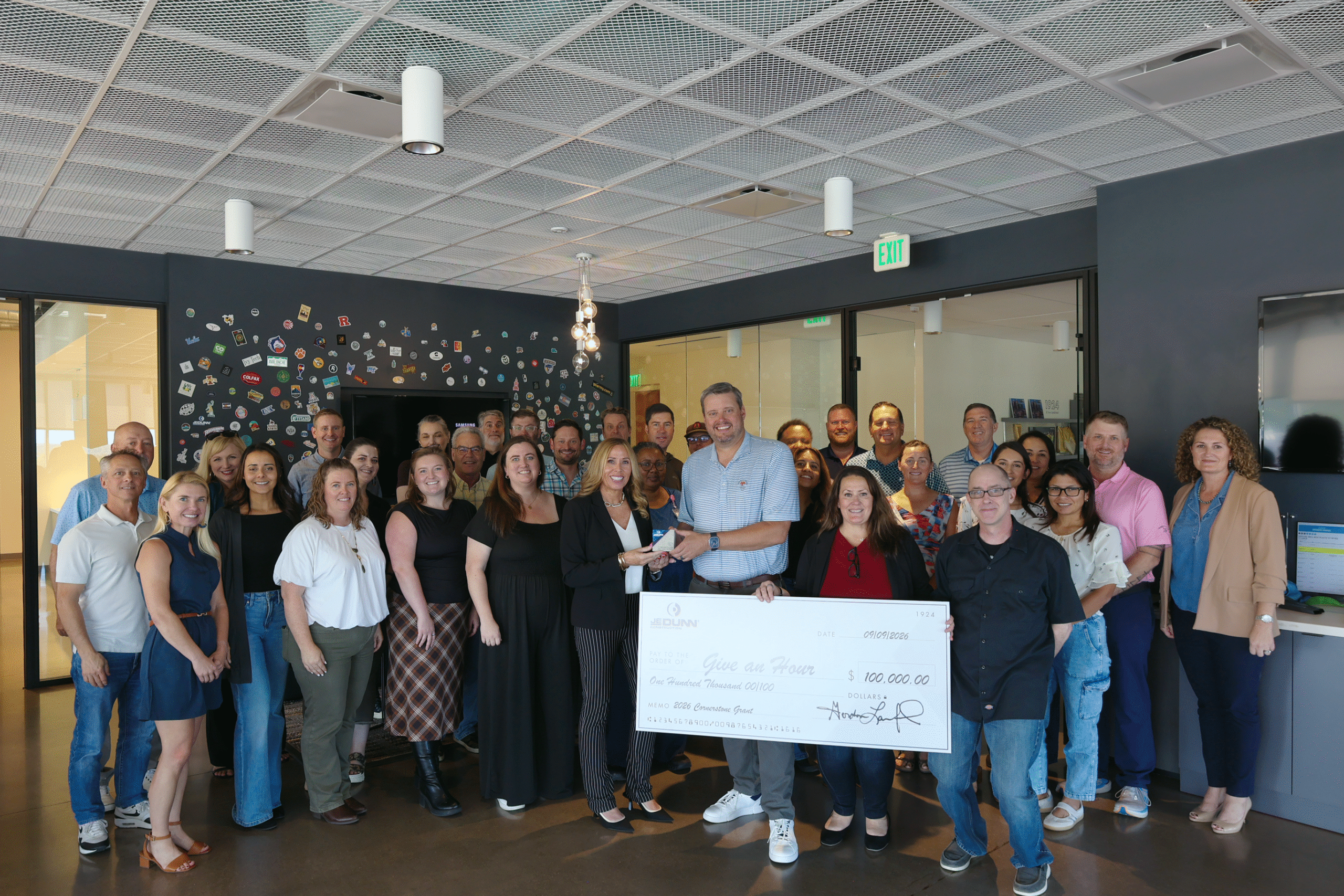 Photograph of donation check to Give an Hour Through the Community Impact Initiative